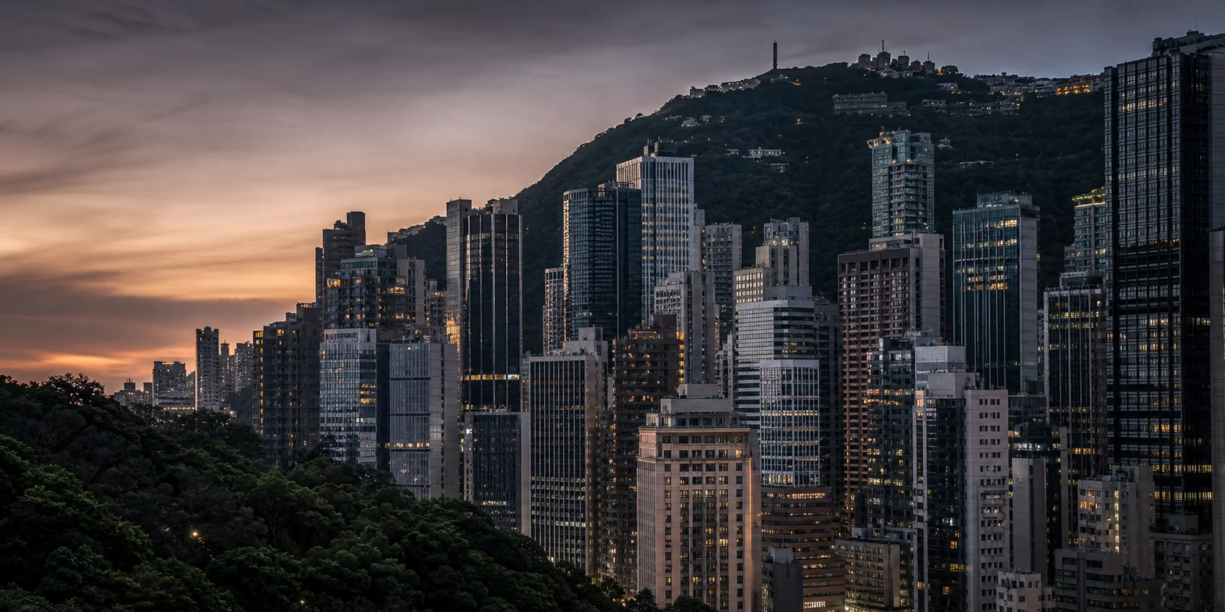 Central's dense commercial skyline rising toward Victoria Peak at dusk